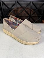 three-quarter view of both shoes showing canvas upper and jute midsole