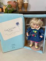 Doll inside open original box showing outfit and accessories