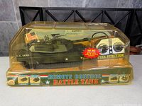 Front view of boxed remote control battle tank showing tank, controller and packaging graphics