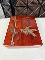 Top view of lacquered wood box with carved bamboo