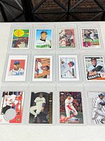 All 12 sleeved reprint cards laid out in four-by-three grid