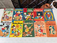 Top row of six comics featuring two Uncle Scrooge issues, Dell Giant Merry Christmas, Donald in Mathmagic Land, Goofy and one additional title