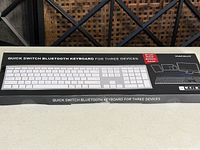 Front of sealed retail box displaying Macally Quick Switch Bluetooth Keyboard for Three Devices