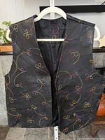 Front view of leather vest showing multicolour embroidery and quilted panels