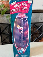 Front view of boxed Mr. Christmas North Pole Power & Light decoration