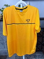 Front view of yellow Nike Dri-FIT shirt on hanger