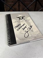 Front cover of Oakland Raiders 'Just Cook Baby!' spiral cookbook showing Jon Gruden signature