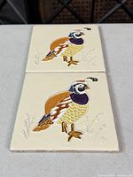 Pair of cream ceramic tiles with quail motif