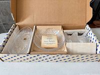 Open box showing four lead crystal dishes with inserts