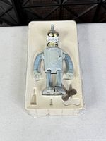 Full view of Bender figure in plastic tray with key