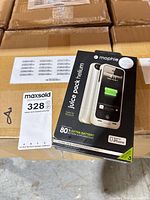 Retail box of Mophie Juice Pack Helium shown on stacked shipping cartons