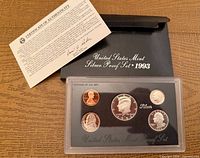 Full view of plastic lens with coins, COA, and box