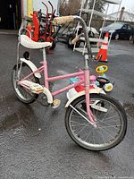 Pink girls’ bicycle with high handlebars