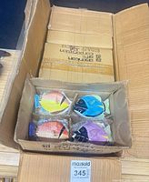Open shipping carton showing one inner carton containing four colourful fish-shaped trinket boxes