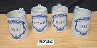Front view of four mugs showing inscriptions Ale, Cyder, Beer, Ale