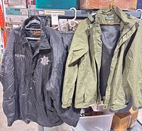 Front view of black Sheriff’s jacket and olive green hooded jacket