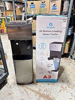 Front view of water cooler beside original box