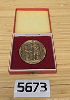 Medal in open presentation case showing full view and included numbering tag