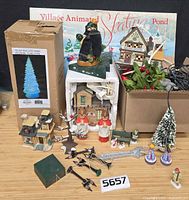 Lot overview showing boxed skating pond, fiber optic tree box, Santa figure, quilt shop building, choirboys, lampposts and accessories