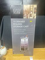 Front of unopened Easy Home storage cart box showing product image and features