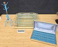 All three items: glass box, jewelry box open, metal necklace rack