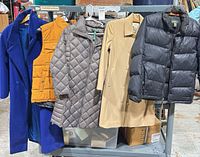 Front view of all five outerwear pieces on rack