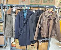 Front view of four jackets on rack