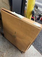 Sealed cardboard carton containing fixture