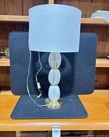 Full view of lamp with shade, base and cord visible