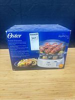 Front of box showing Oster food steamer image and model info