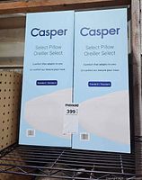 Front view of two Casper Select Pillow boxes on shelf