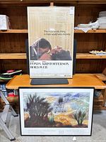 Both framed prints standing on table