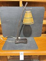 Full view of lamp showing frame, shade, base and power cord
