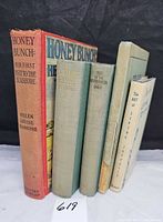 Group shot of all five books standing, showing spines and colours