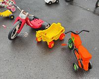 Group view of the three ride-on toys on pavement