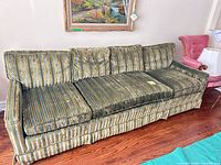 Full view of Art Shoppe striped velvet sofa showing cushions and skirt