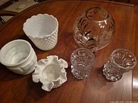 All six glass items laid out: three milk glass pieces, etched globe vase, pair pressed candleholders