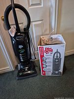 Vacuum standing next to boxed accessories
