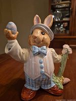 Front view of ceramic bunny teapot with egg and flower handle