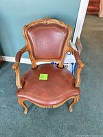 Top view of carved wood French Provincial leather chair