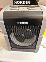 Front view of Nordik heater showing mesh grille and controls