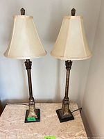 Front view of both buffet lamps showing bases, columns, shades and finials