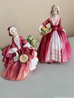 Front view of both figurines showing poses, colors and size