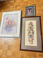 All three framed prints on floor showing relative sizes and frames