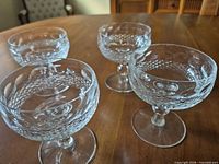 Four crystal coupe glasses on table