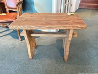 Front angled view of solid wood side table showing legs and stretcher