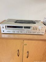 Front view of Technics SA-323 receiver on cabinet