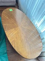 Top view of oval coffee table showing veneer pattern