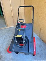 Front view showing chute, auger housing, handle