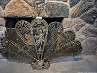 Screen fully opened in front of stone fireplace